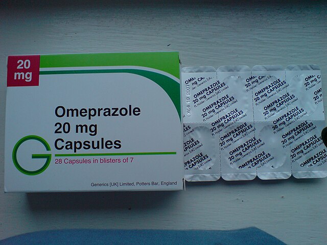 Caixa del medicament omeprazole. A l'esquerra la caixa de cartró blanca retolada com a: "Omeprazole 20mg Capsules" i a la dreta un dels blisters de les càpsules